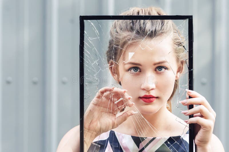 Beautiful teen girl holding broken glass in her hands. concept feminism. stock photography Beautiful teen girl holding broken glass in her hands. concept feminism. stock photography
