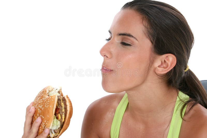 Beautiful Teen Girl Holding Colorful Weights And A Giant Cheeseburger royalty free stock images Beautiful Teen Girl Holding Colorful Weights And A Giant Cheeseburger royalty free stock images