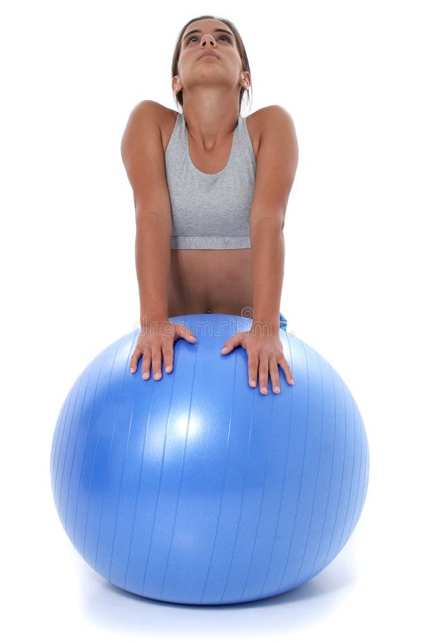 Beautiful teen girl in workout clothes stretching on exercise ball. Shot in studio over white. Beautiful teen girl in workout clothes stretching on exercise ball. Shot in studio over white.