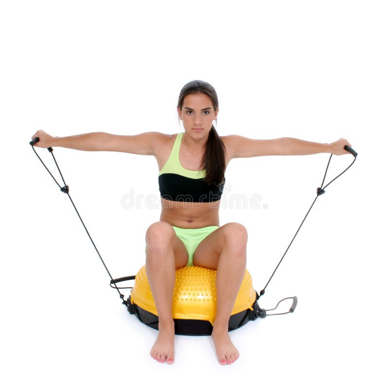 Beautiful dark haired tan teen girl in workout clothes sitting on workout equipment. Shot with the Canon 20D. Beautiful dark haired tan teen girl in workout clothes sitting on workout equipment. Shot with the Canon 20D.