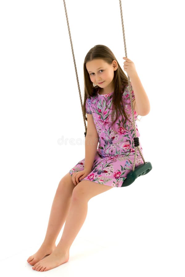 Beautiful Teen School Girl Swinging on a Swing