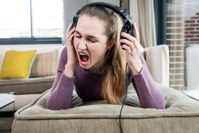 Beautiful teenage girl in pain screaming suffering from loud music stock photos Beautiful teenage girl in pain screaming suffering from loud music stock photos