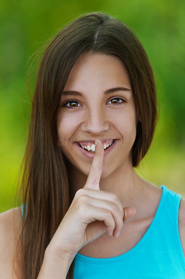 Beautiful teenage girl puts finger stock image Beautiful teenage girl puts finger stock image