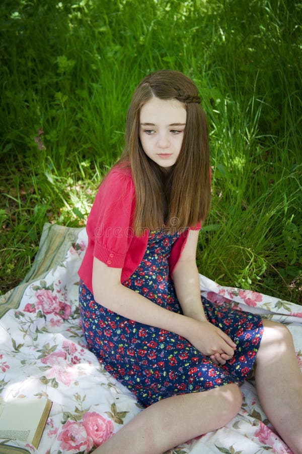 Beautiful Teenage Girl Sitting on a Blanket in a Meadow Stock Image ...