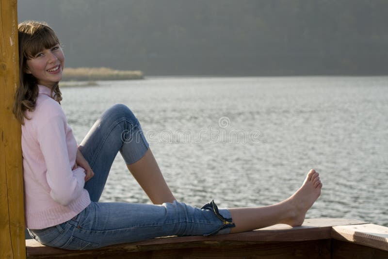 Beautiful teenager over lake