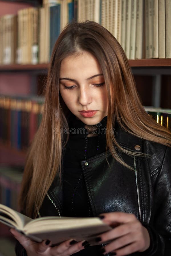 Beautiful Teenager Schoolgirl Reading a Book in the Library Stock Image ...