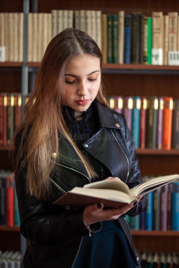Beautiful Teenager Schoolgirl Reading a Book in the Library Stock Photo ...