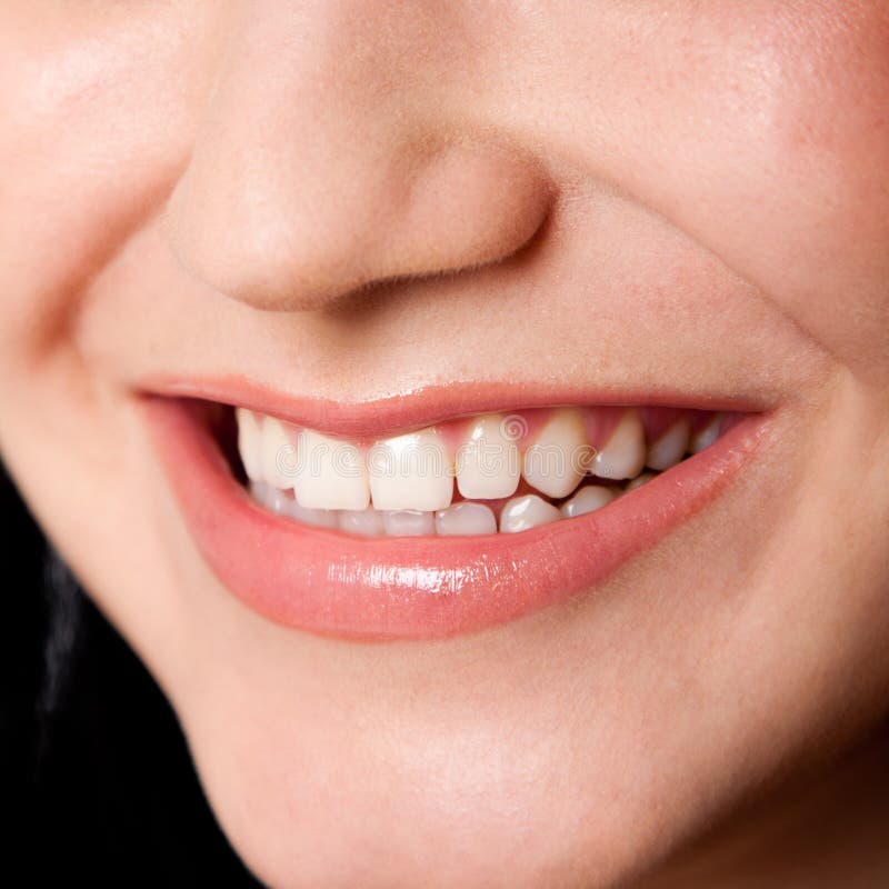 Beautiful white teeth in a perfect happy smile of a female face, dentist tooth whitening concept. Beautiful white teeth in a perfect happy smile of a female face, dentist tooth whitening concept.