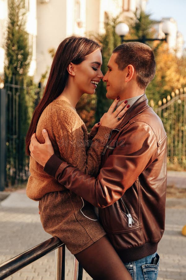 Beautiful tender couple posing in autumn park in elegant clothes