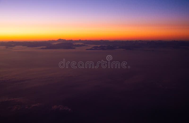 Beautiful thick clouds in the sky from the height of the flight of the airplane with a view of the sunset. Airplane height stock images, royalty-free photos and pictures