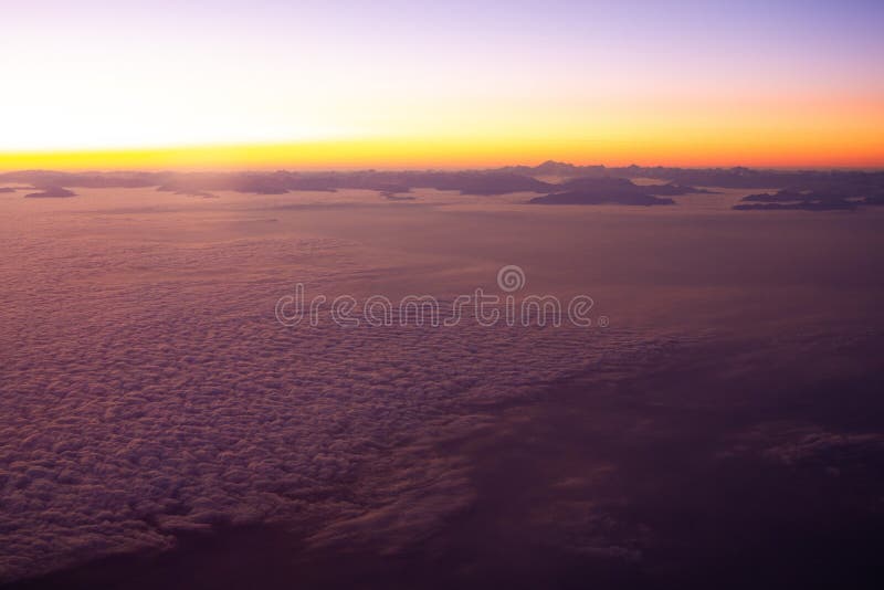 Beautiful thick clouds in the sky from the height of the flight of the airplane with a view of the sunset. Airplane height stock images, royalty-free photos and pictures