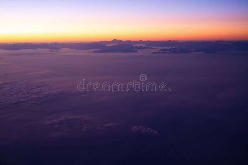 Beautiful thick clouds in the sky from the height of the flight of the airplane with a view of the sunset. Airplane height stock images, royalty-free photos and pictures