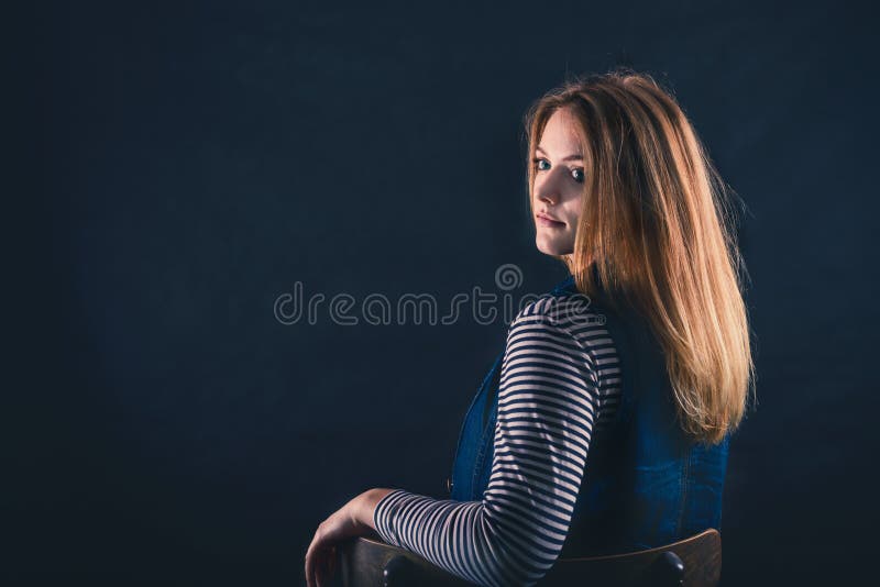 Beautiful thoughtful girl close up in the dark