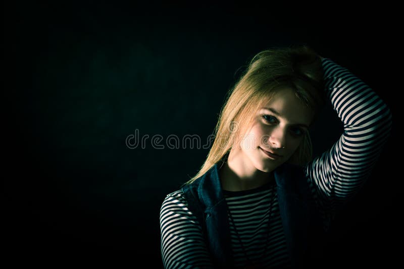 Beautiful thoughtful girl close up in the dark