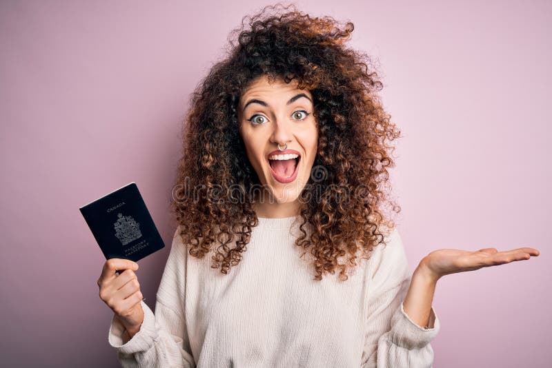 Beautiful Tourist Woman With Curly Hair And Piercing Holding Canada Canadian Passport Id Very