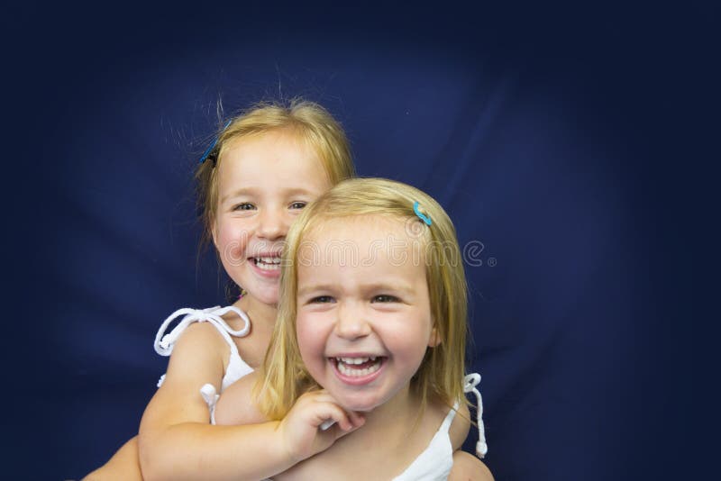 Beautiful twin little girls smiling