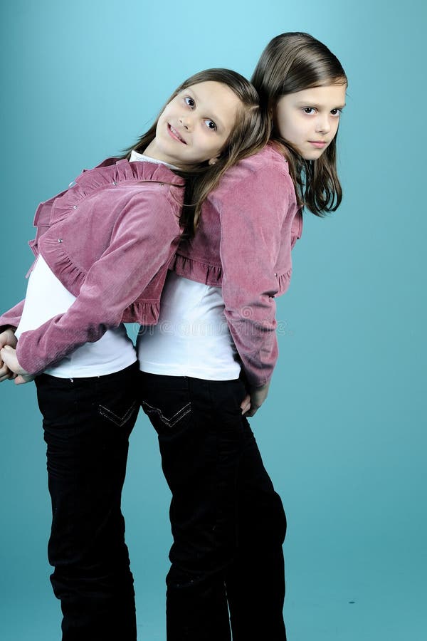 Beautiful twins posing in studio