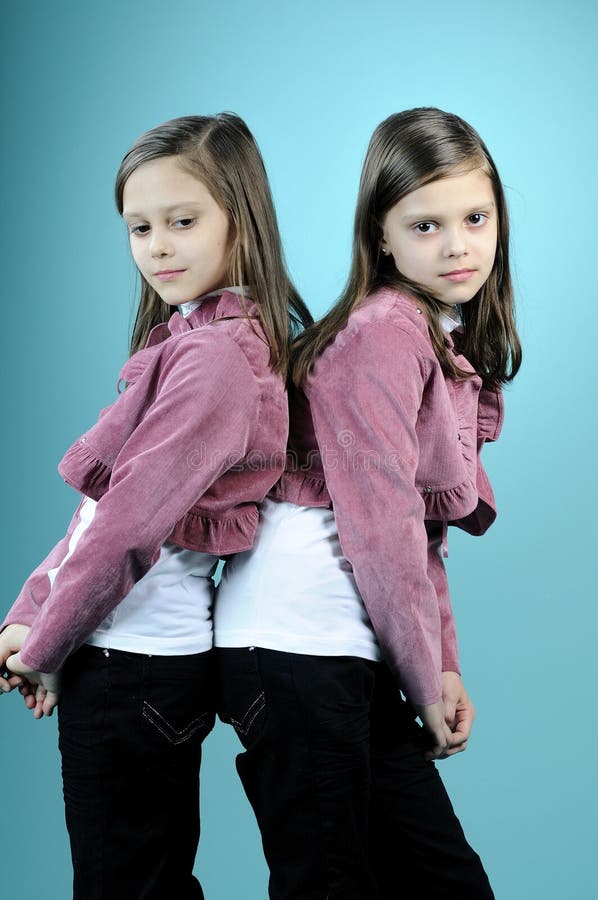 Beautiful twins posing in studio