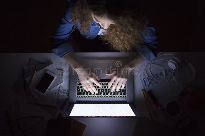 A beautiful university student having evening online class, e-learning sitting at home. Online consultation. stock images