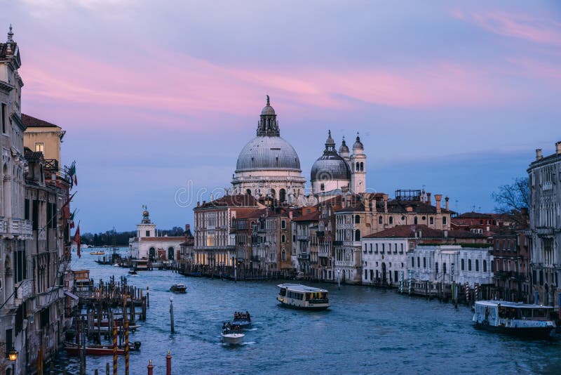 Beautiful view on Basilica di Santa Maria della Salute in golden evening light at sunset in Venice, Italy