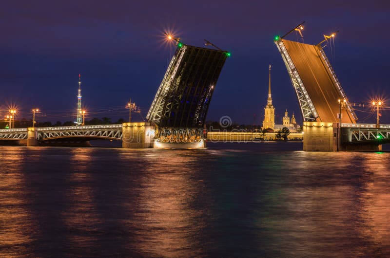 Beautiful view of the breeding of bridges in the night St. Petersburg from the embankment of the Neva River
