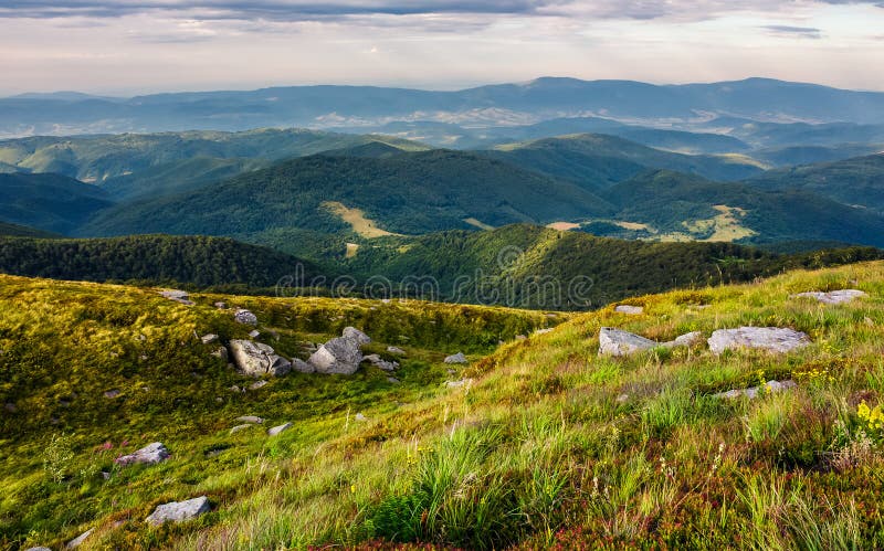 Beautiful view of Carpathians in dappled light. wonderful colors of summer landscape in mountains on a cloudy day observed from the top of a hill. location Runa mountain, Ukraine