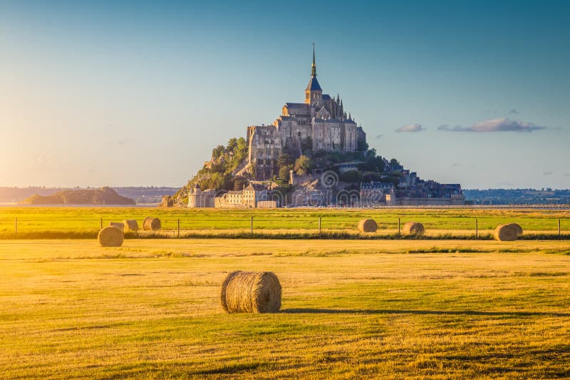 Hermoso de famoso montana en dorado la luz sobre el atardecer en el verano pacas de heno sobre el campo antiguo estilo filtrar efecto,, Francia.