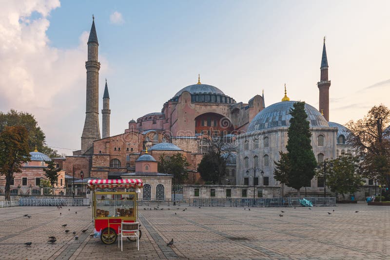Beautiful view on Hagia Sophia in Istanbul, Turkey with simit cart on empty square on sunrise. Travel destination