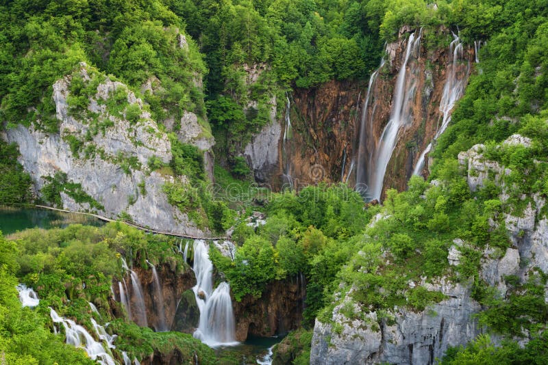 Beautiful view of waterfalls with turquoise water and wooden pathway through over water. Plitvice Lakes National Park, Croatia. Fa stock image Beautiful view of waterfalls with turquoise water and wooden pathway through over water. Plitvice Lakes National Park, Croatia. Fa stock image