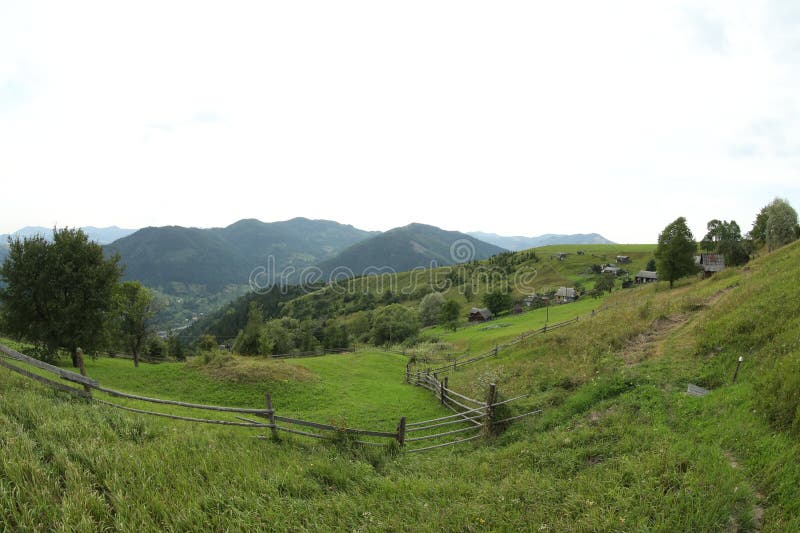 Beautiful view of wooden fence in mountains under sky stock photo