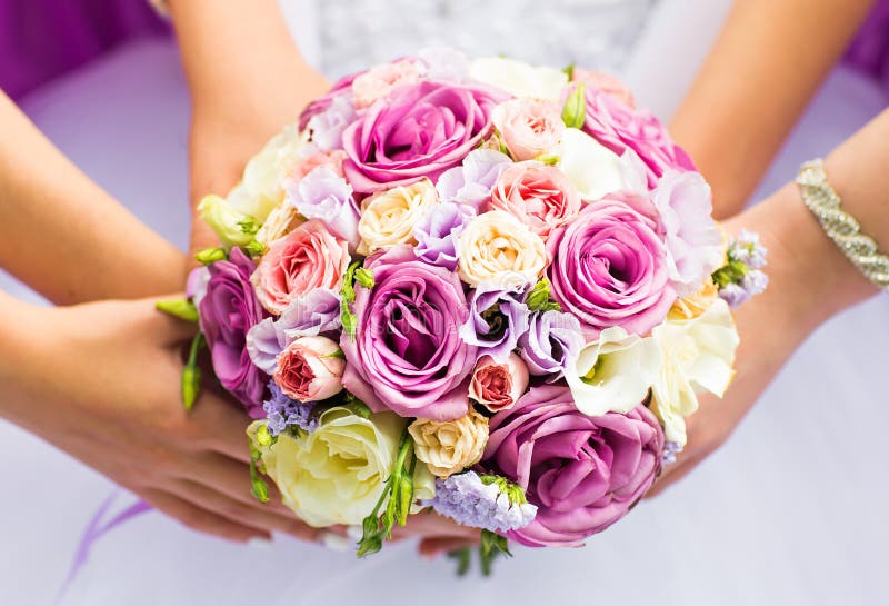 Beautiful wedding bouquet in hands of the bride close-up. Elegance, detail.