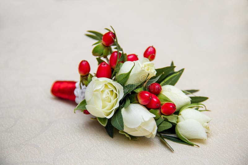 Beautiful wedding boutonniere of varios flowers on white wooden background royalty free stock photos Beautiful wedding boutonniere of varios flowers on white wooden background royalty free stock photos