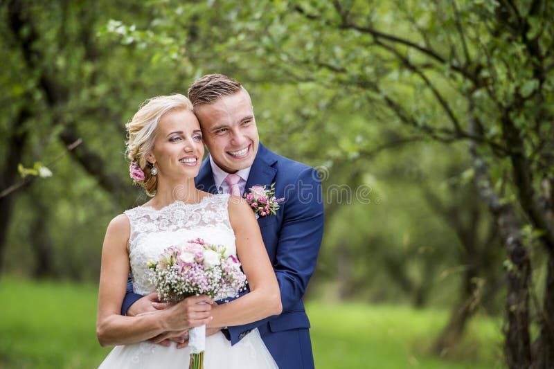 Beautiful young wedding couple outside in nature. Happy embracing couple stock images, royalty-free photos and pictures