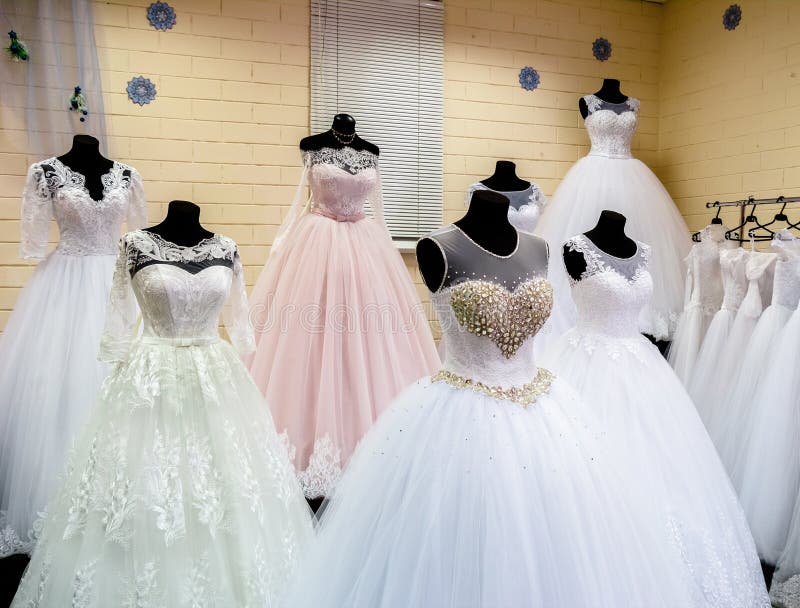 Beautiful Wedding Dresses on Hangers in Wedding Atelier Stock Image