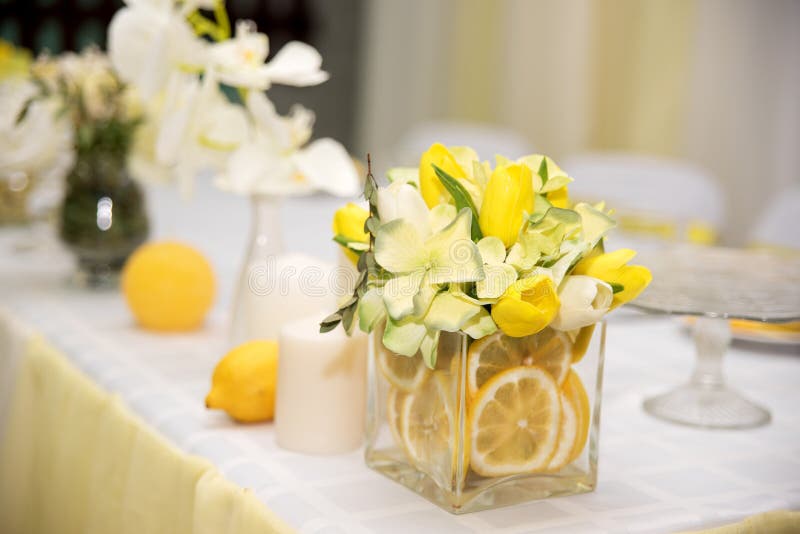 A beautiful wedding table decoration with stylized yellow lemon