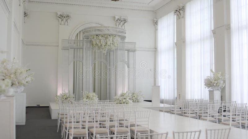 Beautiful white arch for indoor wedding ceremony