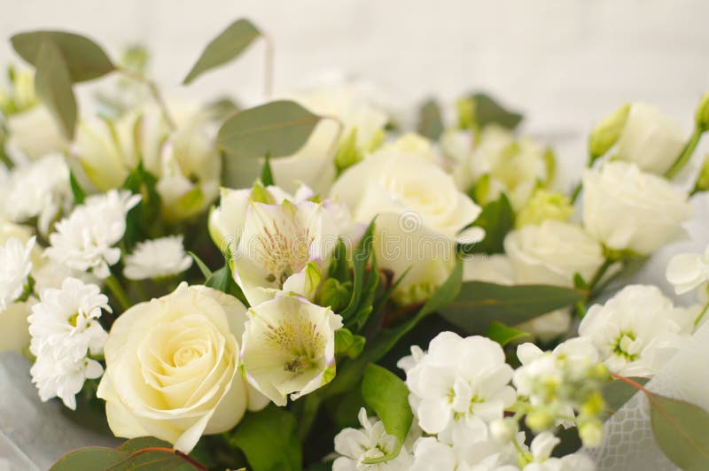 Beautiful white bouquet in a wicker basket.