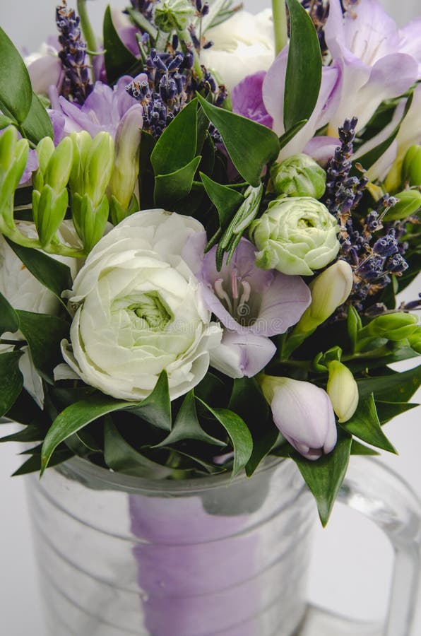 Beautiful white and lilac flowers buttercup ranunculus, lavender, fresia macro. Pastel colors. Holiday gift. Rustic style, still l. Ife. Wedding bouquet. Bridal stock photos Beautiful white and lilac flowers buttercup ranunculus, lavender, fresia macro. Pastel colors. Holiday gift. Rustic style, still l. Ife. Wedding bouquet. Bridal stock photos
