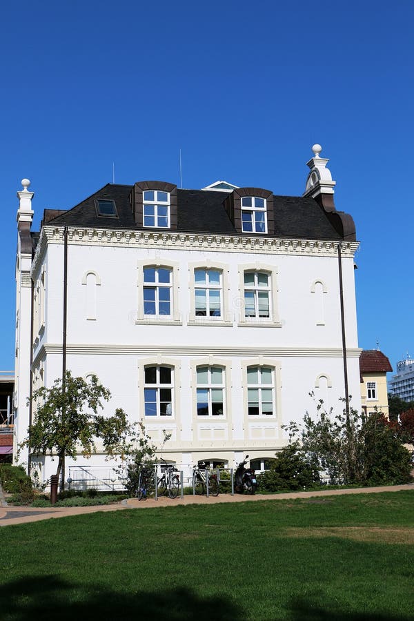 Beautiful white mansion with a small park in the sunshine stock photos