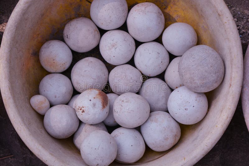 Beautiful White Stone Balls in Clay Vessel Background Stock Photo