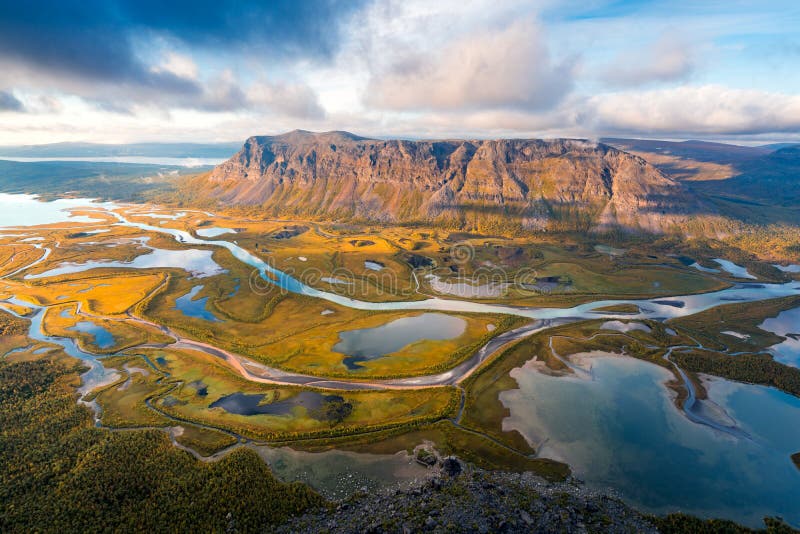 Beautiful, wild arctic valley viewed from mountain top in epic early morning light. Remote Rapa river valley from the. Top of Skierfe in Sarek national park in