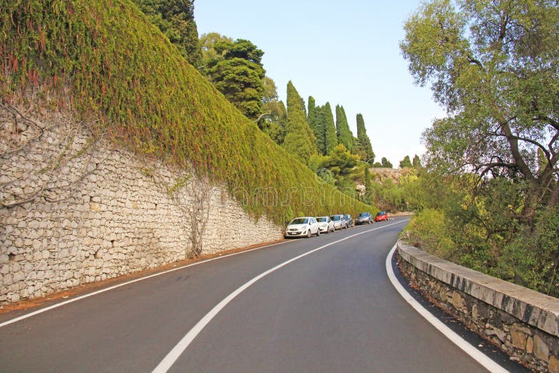 Beautiful Winding and Picturesque Green Road in the City of Taormina. The island of Sicily, Italy royalty free stock photo Beautiful Winding and Picturesque Green Road in the City of Taormina. The island of Sicily, Italy royalty free stock photo