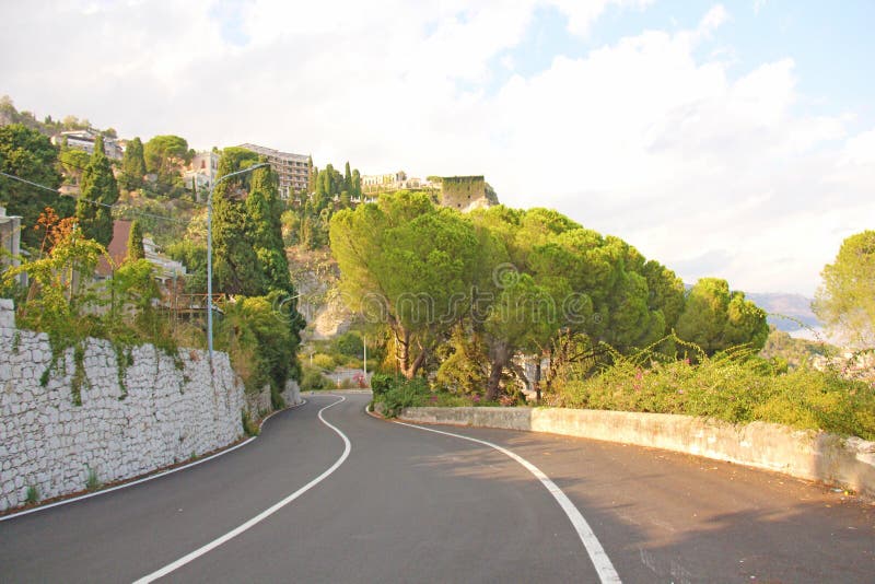 Beautiful Winding and Picturesque Green Road in the City of Taormina. The island of Sicily, Italy royalty free stock photo Beautiful Winding and Picturesque Green Road in the City of Taormina. The island of Sicily, Italy royalty free stock photo