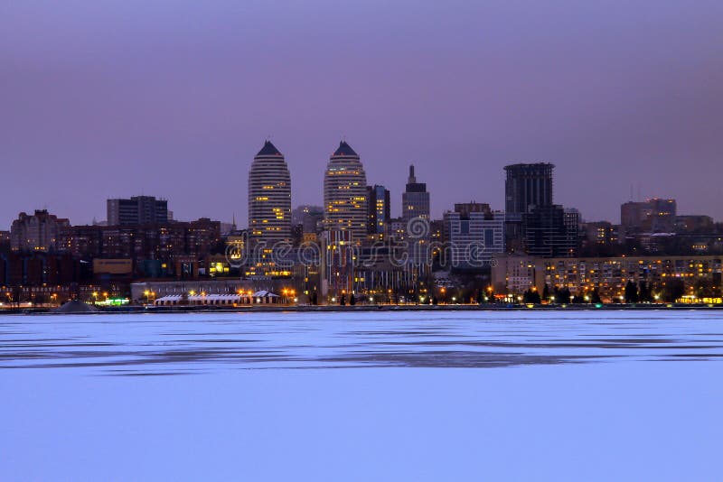Beautiful winter view of the Dnepr city in the evening, the ice of the frozen Dnieper river is covered with fresh snow. stock photography Beautiful winter view of the Dnepr city in the evening, the ice of the frozen Dnieper river is covered with fresh snow. stock photography