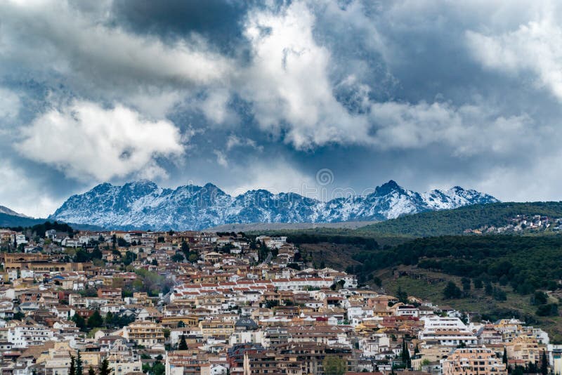 Beautiful Winter View Over a Snowy Mountain. Snow clouds over a village in the snowy mountains of the Sierra Nevada of Spain