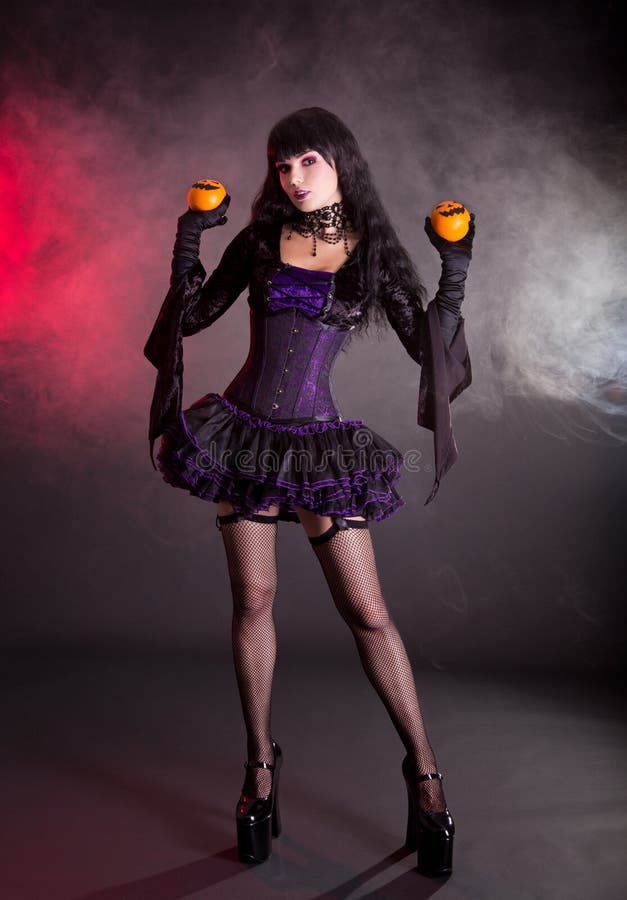 Young Woman in Victorian Purple and Black Halloween Outfit Stock 