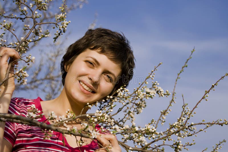 Beautiful woman amongst spring blossom