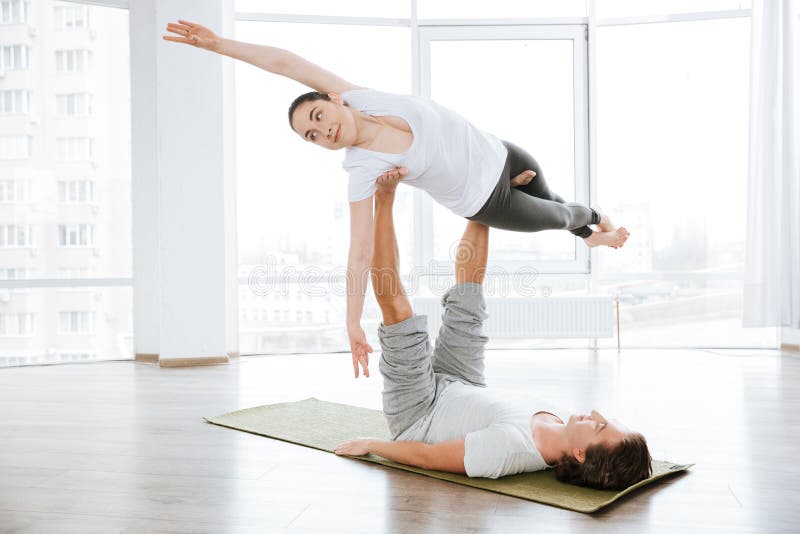 beautiful-woman-balancing-doing-acro-yoga-partner-women-studio-72872296.jpg