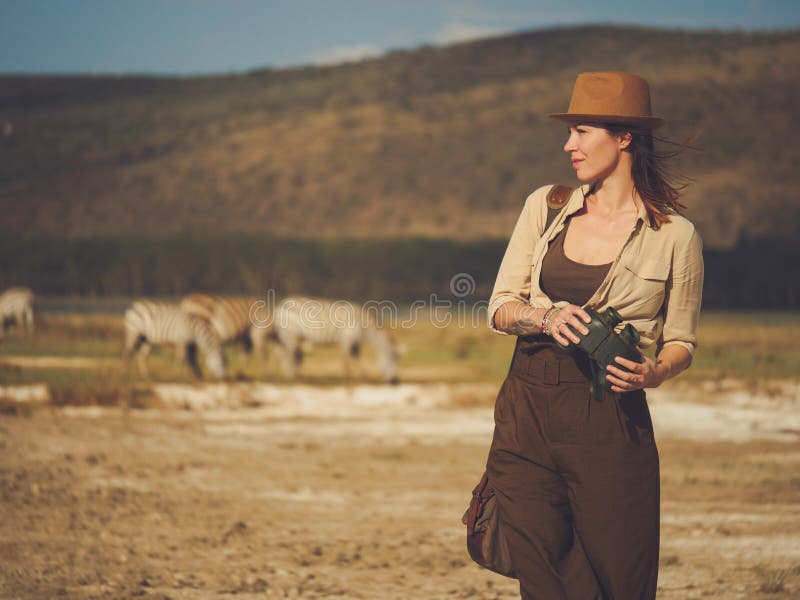 Beautiful Woman with Binoculars at Savanna in Kenya Stock Photo Image