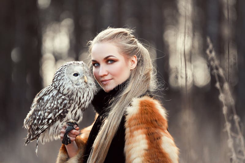 Beautiful Woman in a Black Dress with an Owl on His Arm. Blonde with ...